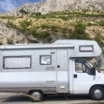 Zdjęcie KamperaFiat Ducato II Dethleffs stojącego na tle gór i skał